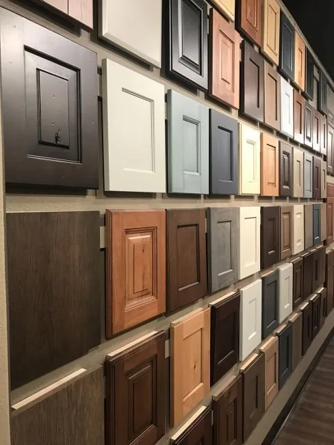 Cabinet door samples in a range of finishes on the Plush Designs showroom wall