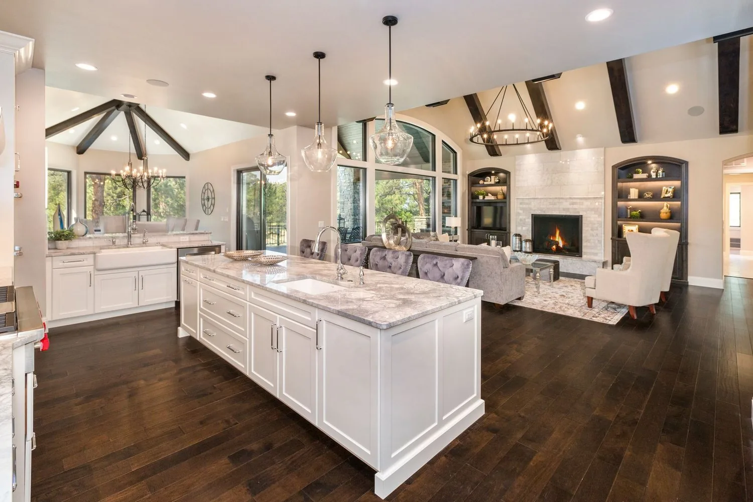 Fox Chase Kitchen by Plush Designs, with white cabinetry, a large island and exposed beams