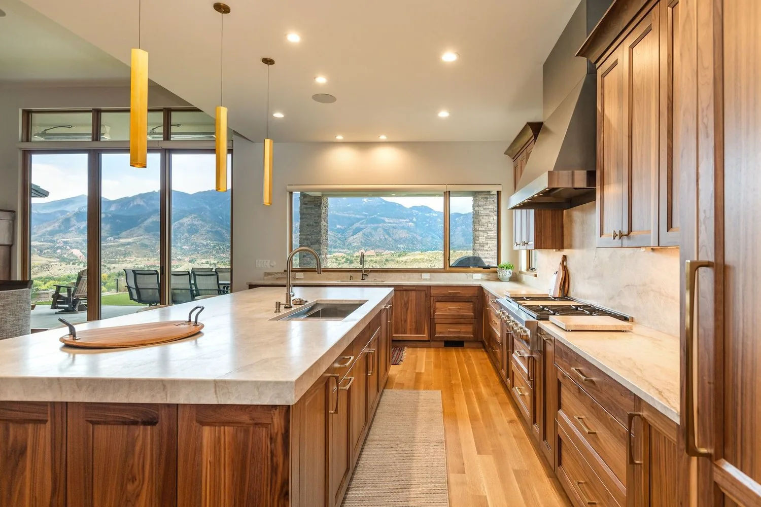 The Garden View kitchen by Plush Designs, with a long island and windows facing the mountains