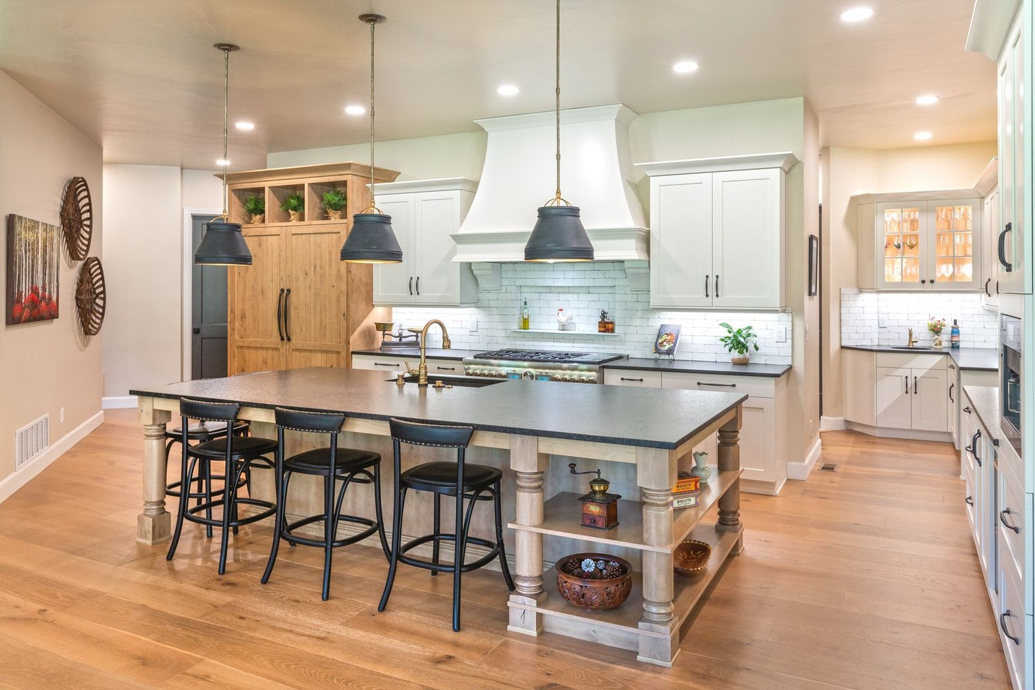 Palmer Divide kitchen by Plush Designs, with a painted island, bar stools and light cabinetry
