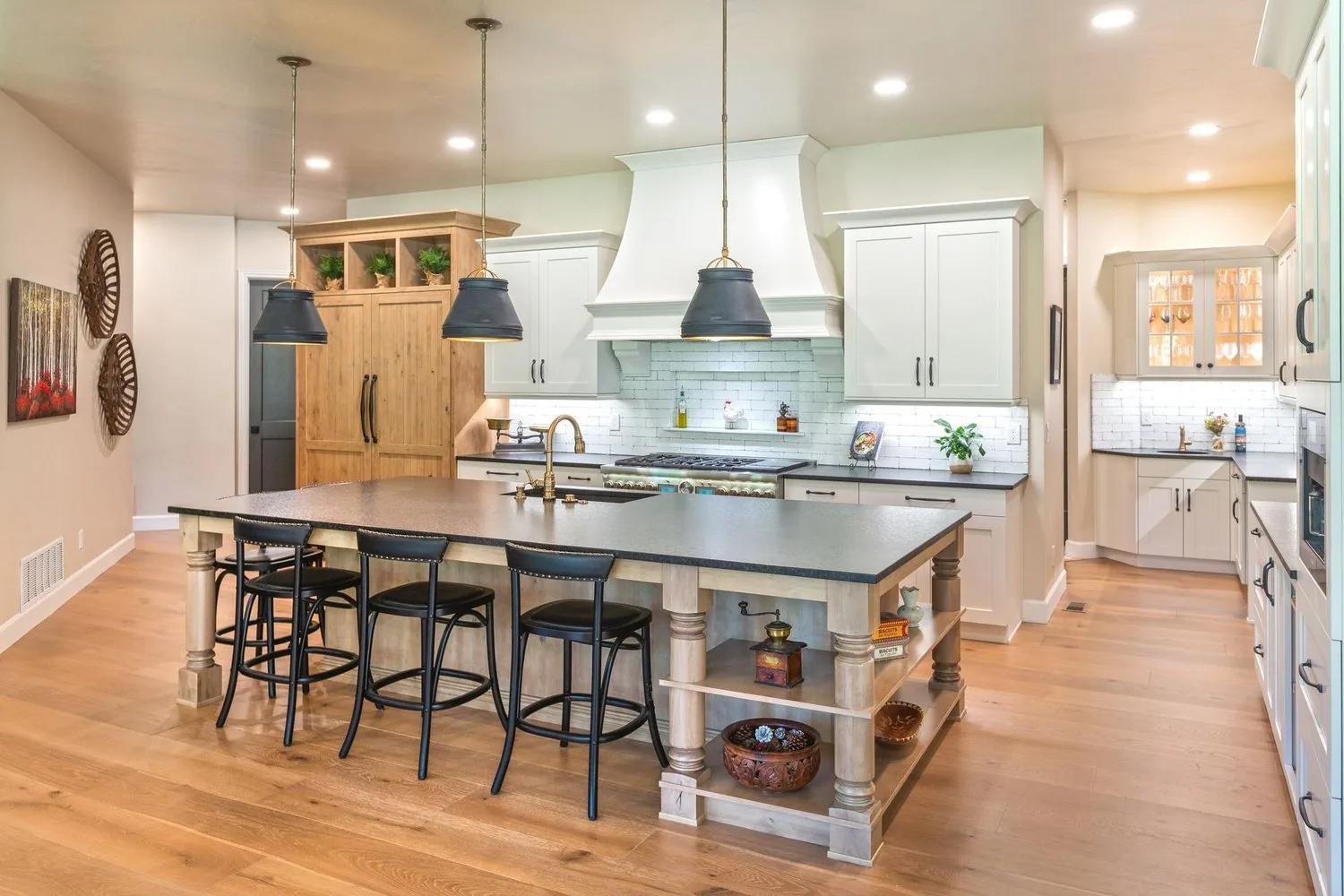 Palmer Divide kitchen by Plush Designs, with a painted island, bar stools and light cabinetry